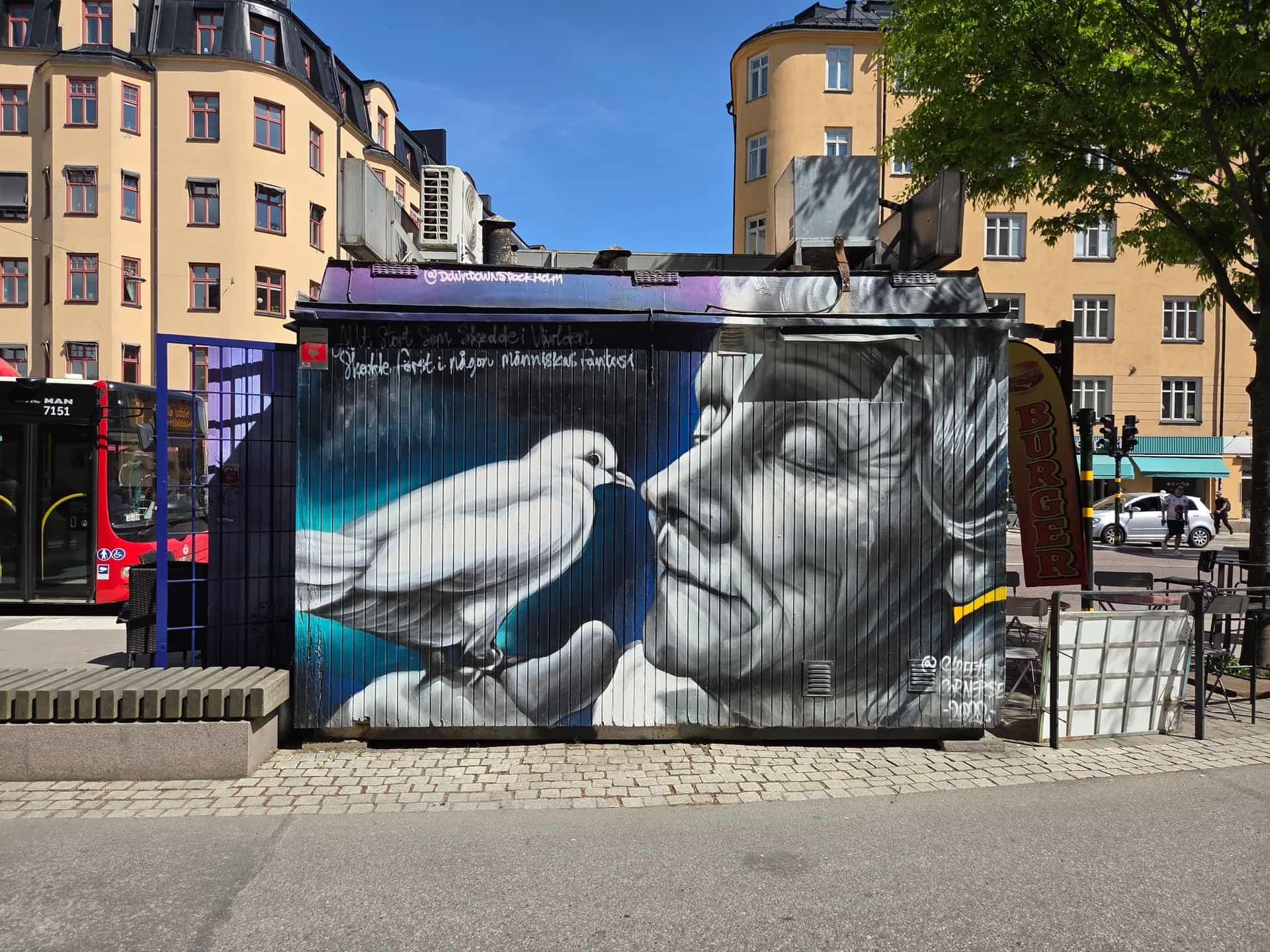Mural: Face in grayscale and white dove. Vertical lines in the background
