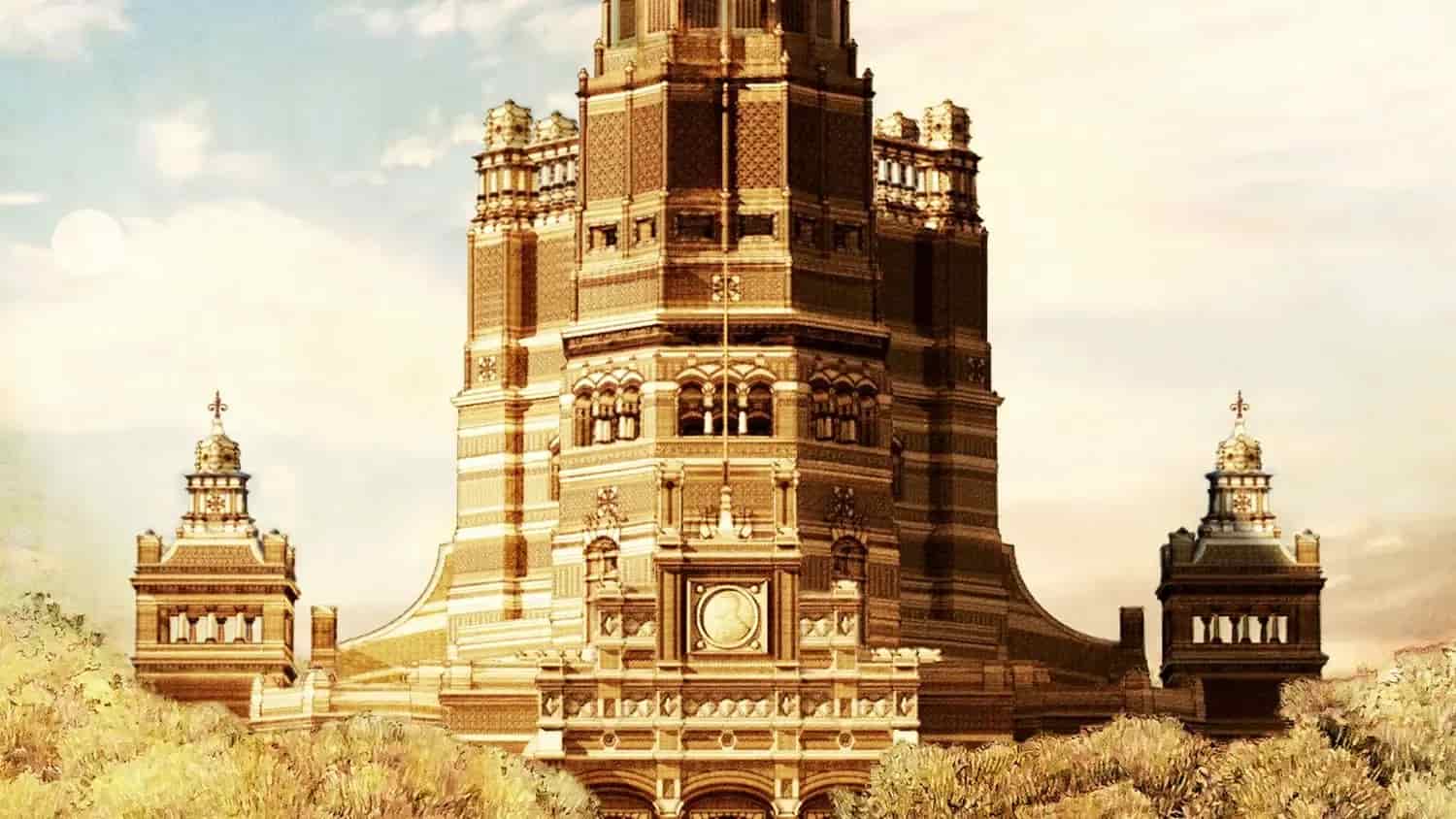 Tall beige tower with side buildings and a clock. Cloudy sky