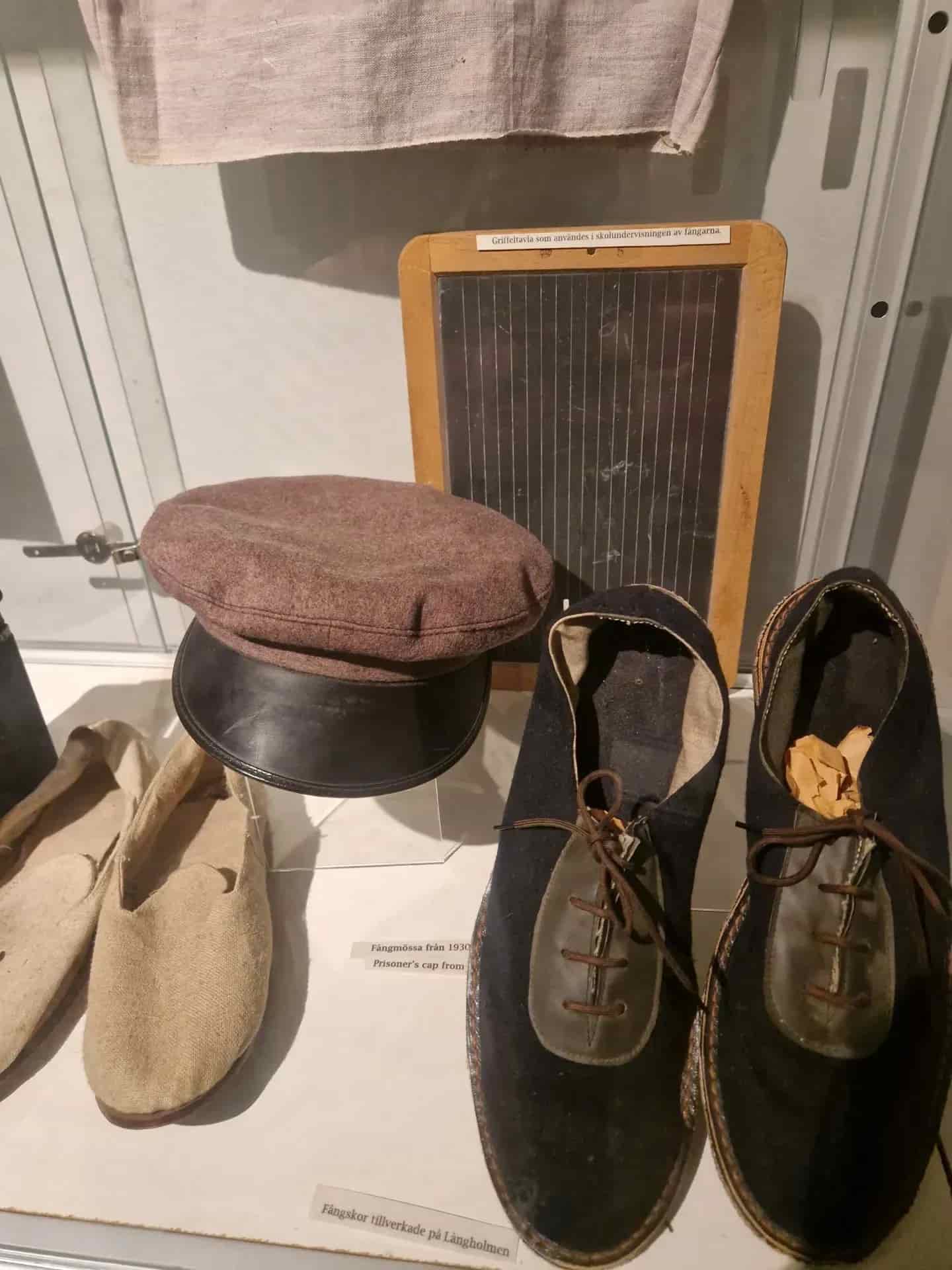 Exhibition: Cap, slate and prison shoes made at Långholmen