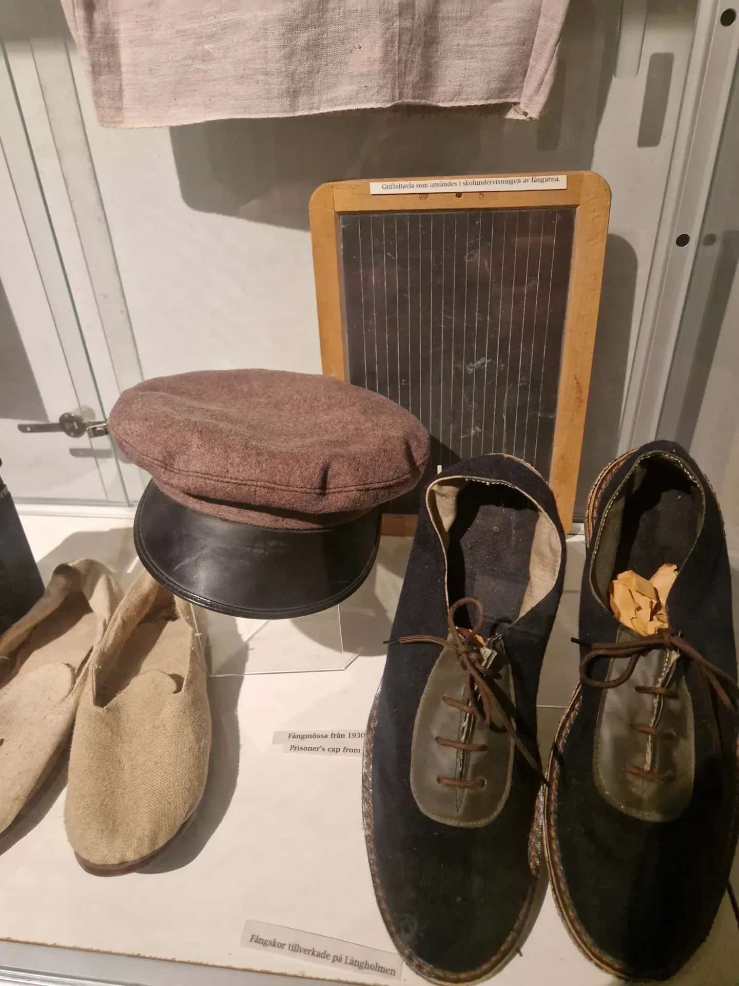 Exhibition: Cap, slate and prison shoes made at Långholmen