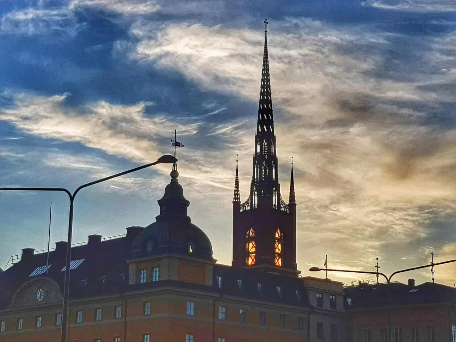 Silhouette of buildings, church tower and sky with clouds